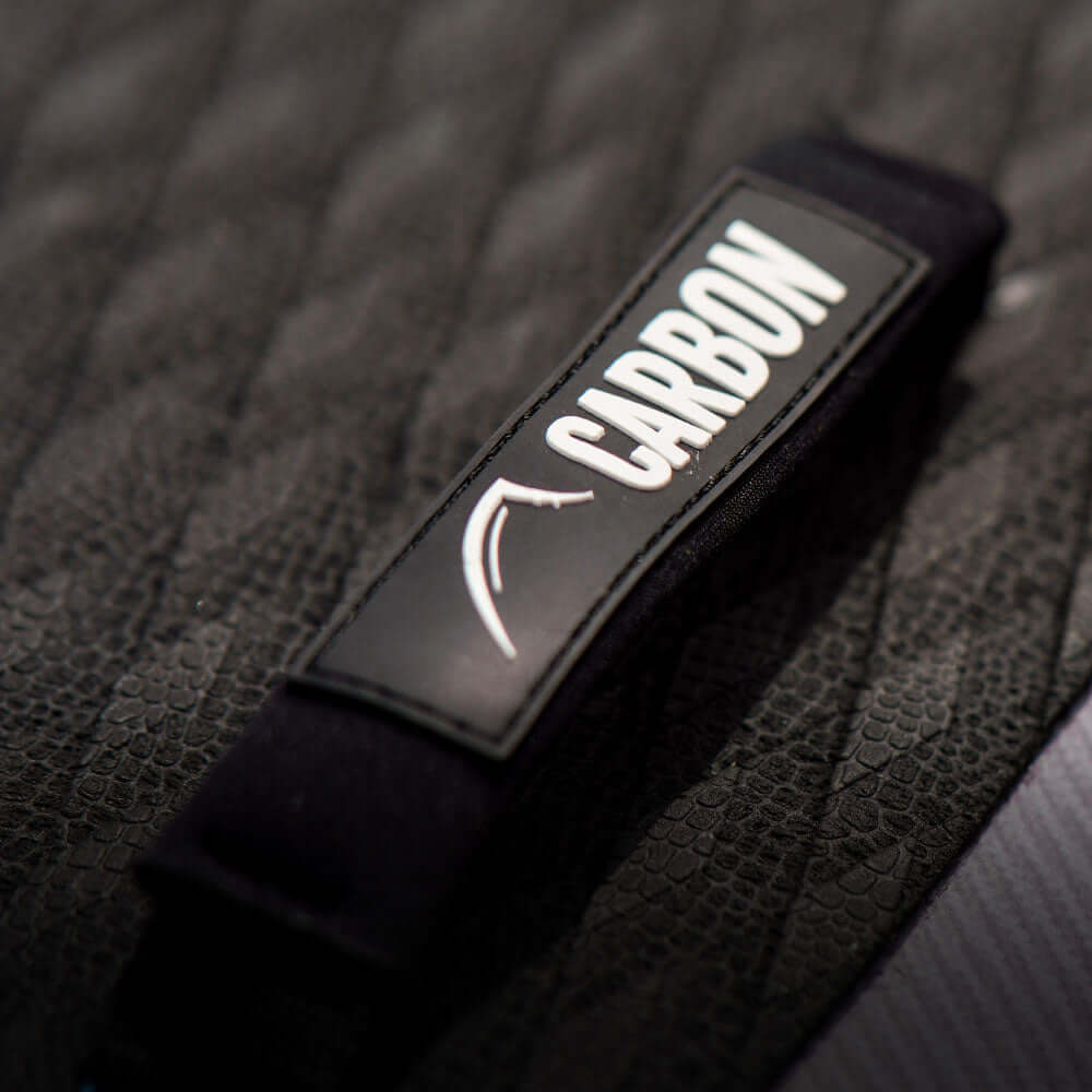 Close-up of a black textured surface with a label reading 'CARBON' on a strap