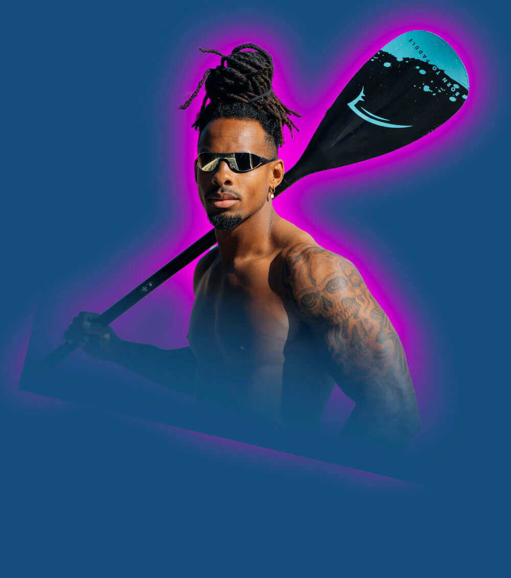 Muscular person with tattoos holding a paddle, wearing sunglasses, against a blue and pink background.