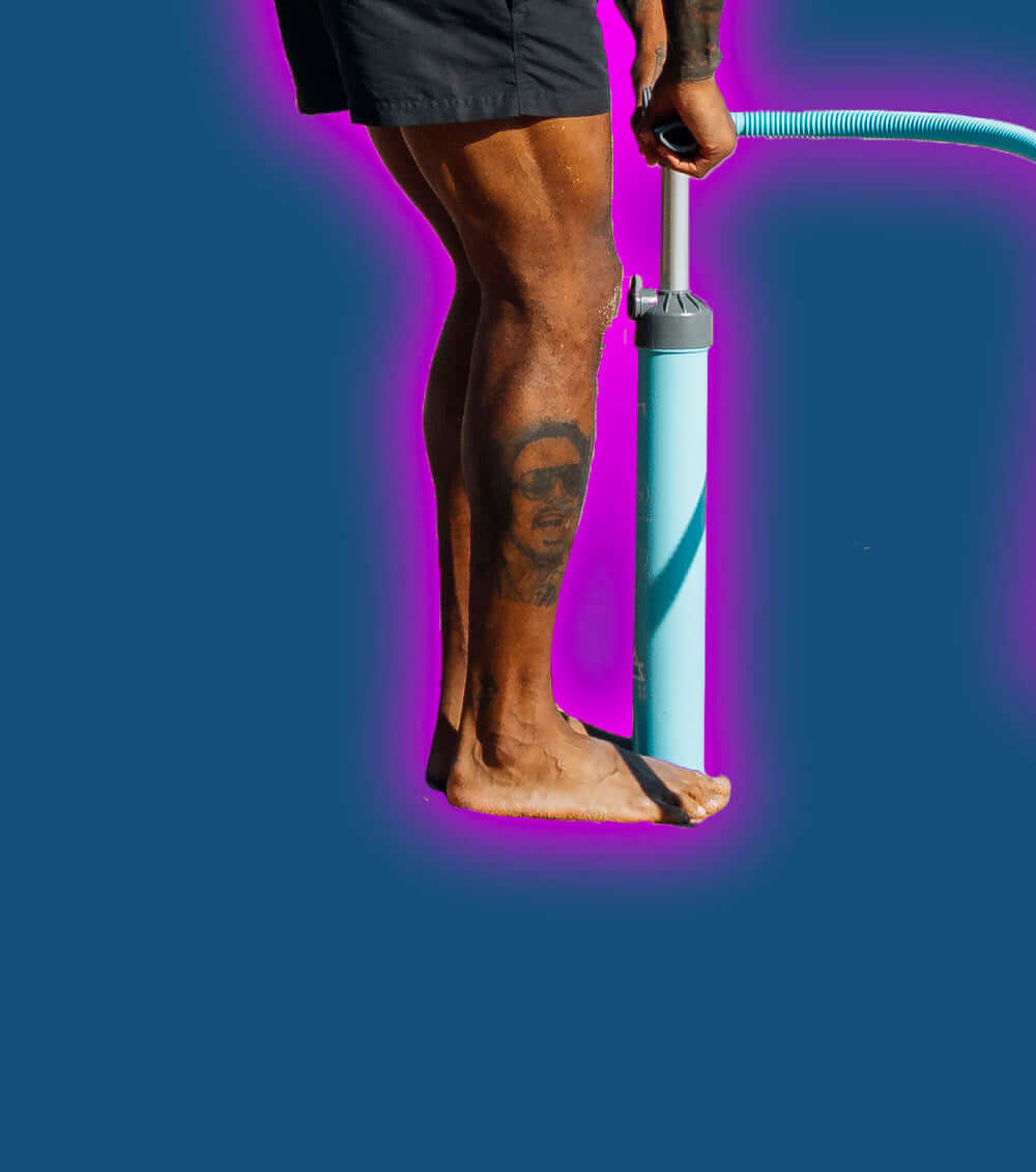 Person with a tattoo on their leg using a blue pump on a dark background