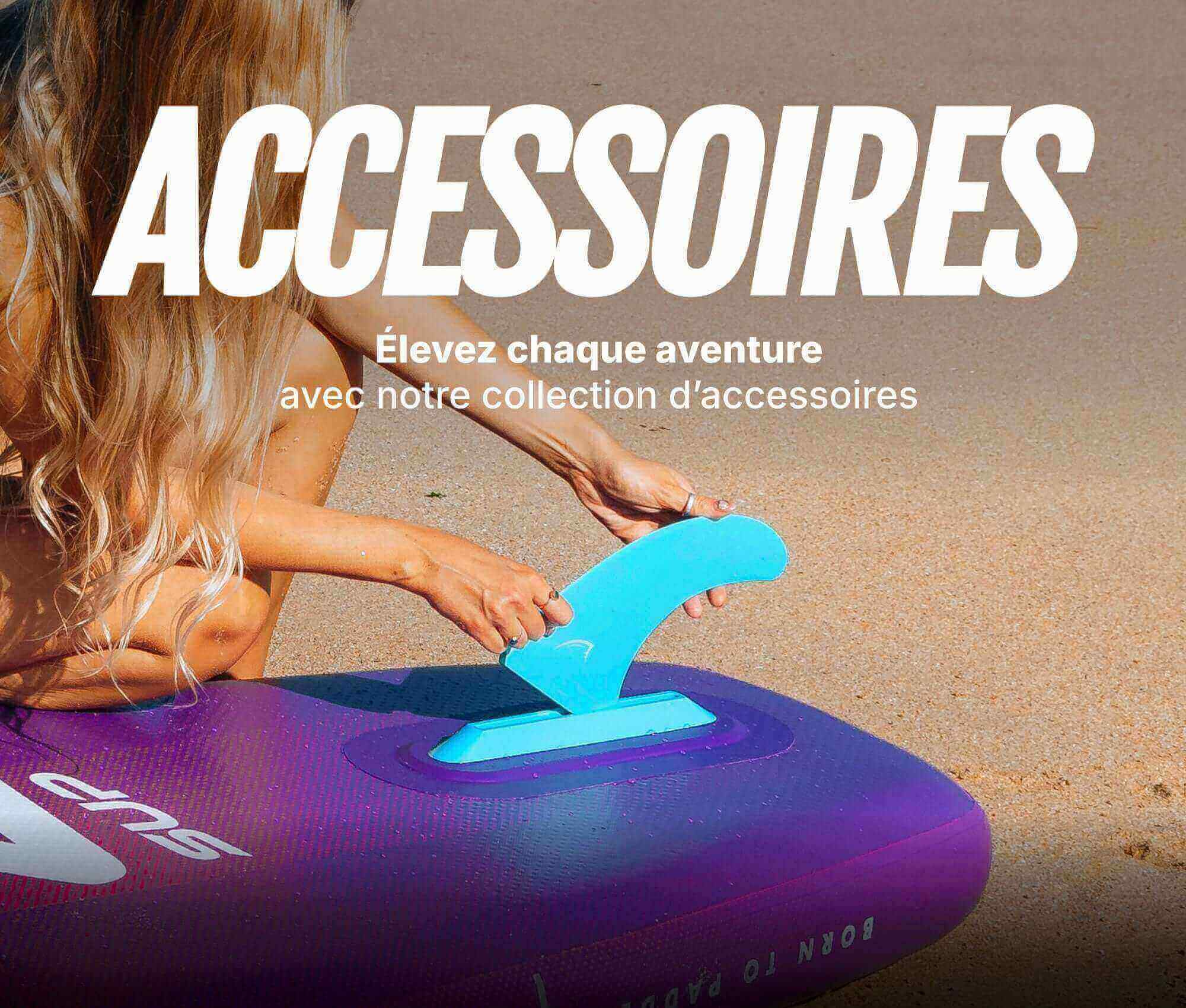 Woman attaching a blue fin to a purple inflatable paddleboard on the beach