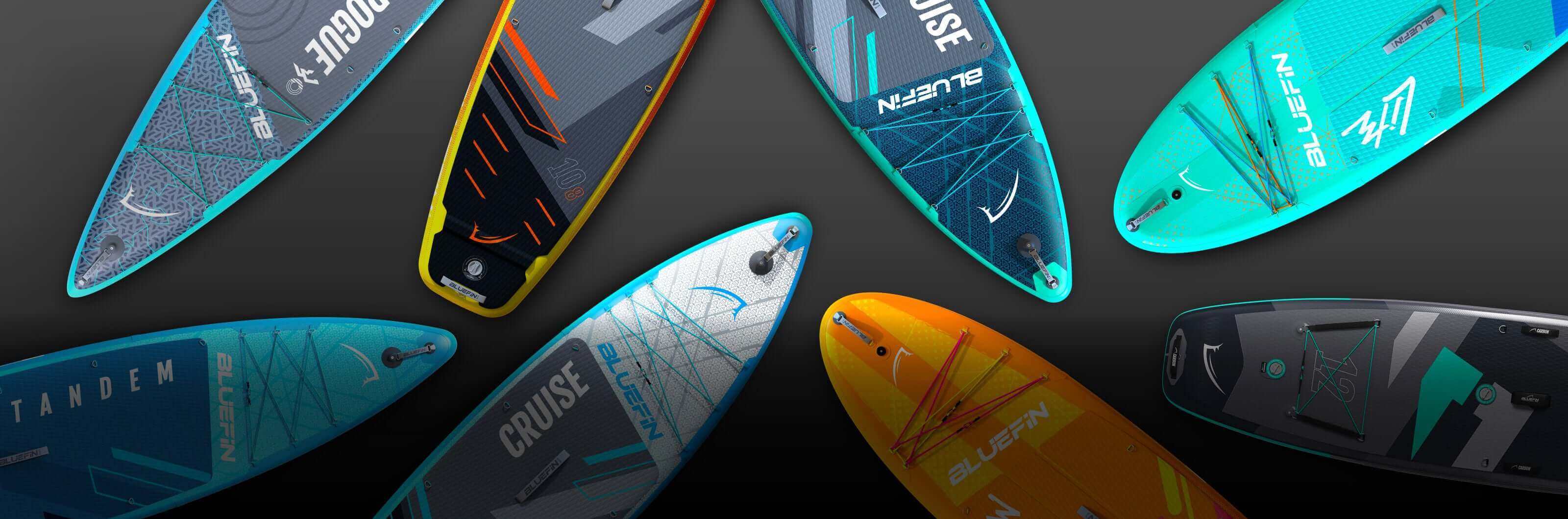 Collection of colorful inflatable paddleboards with various designs and features on a dark background