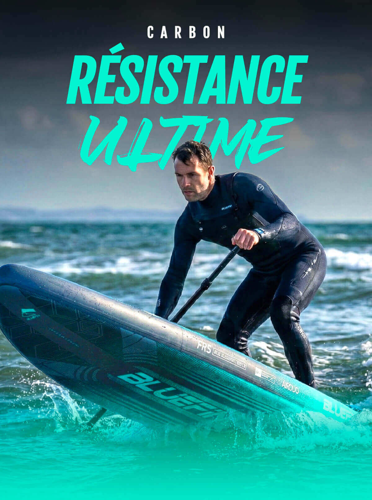 Paddleboarder in a wetsuit paddling on water, using a blue inflatable board with a textured surface.