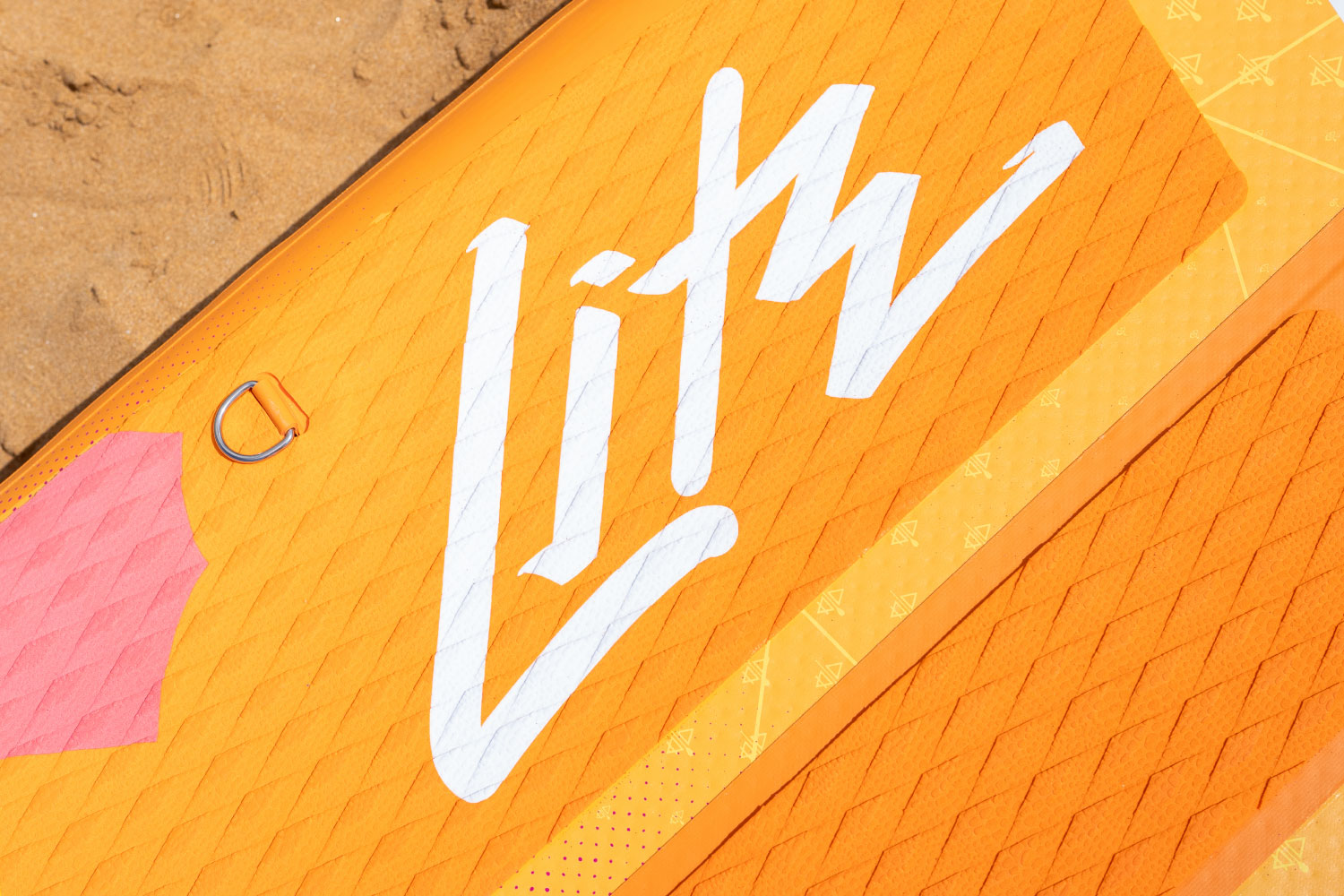 Orange inflatable paddleboard with white logo, textured surface, and a pink accent on the side