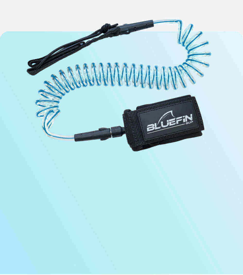 Coiled safety leash with black strap and blue cord, designed for paddleboarding use.