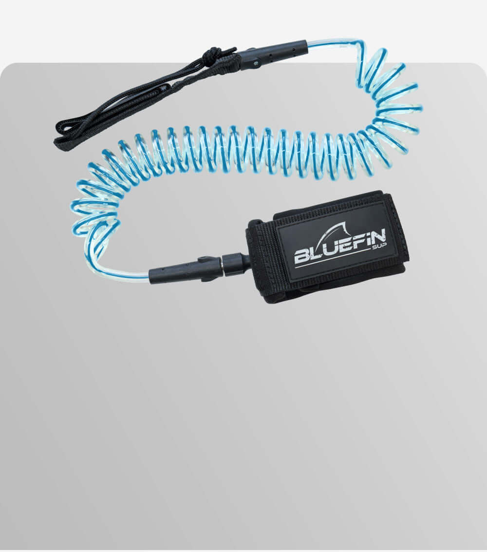 Coiled blue leash with black strap labeled BLUEFIN SUP for paddleboarding safety.