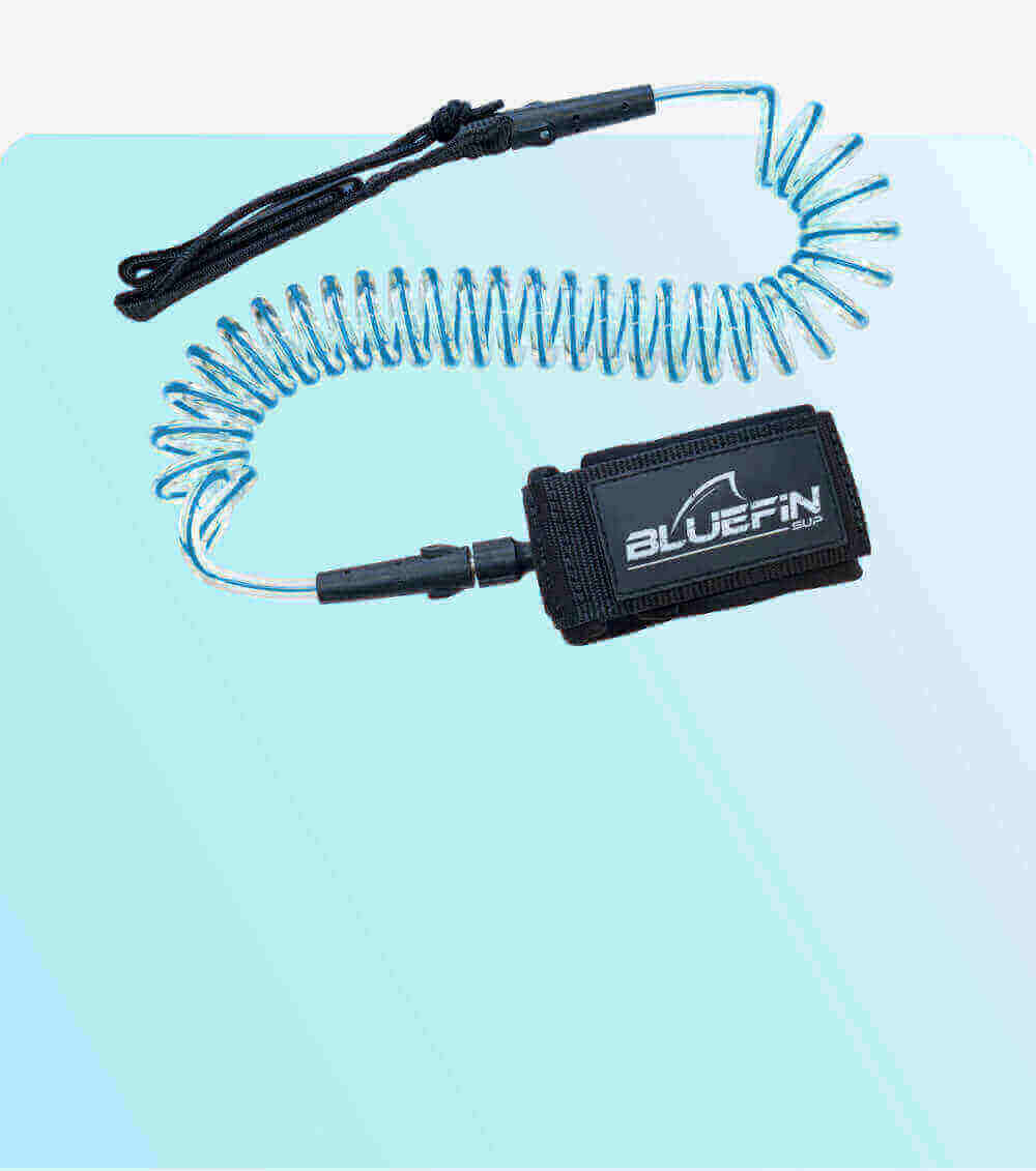 Coiled safety leash with black strap and blue cord, featuring a BLUEFIN SUP logo on the attachment.