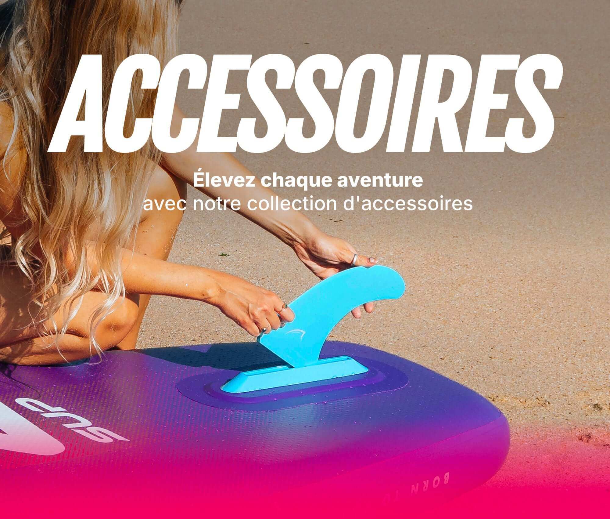 Inflatable paddleboard with a blue fin being attached, sandy beach in the background