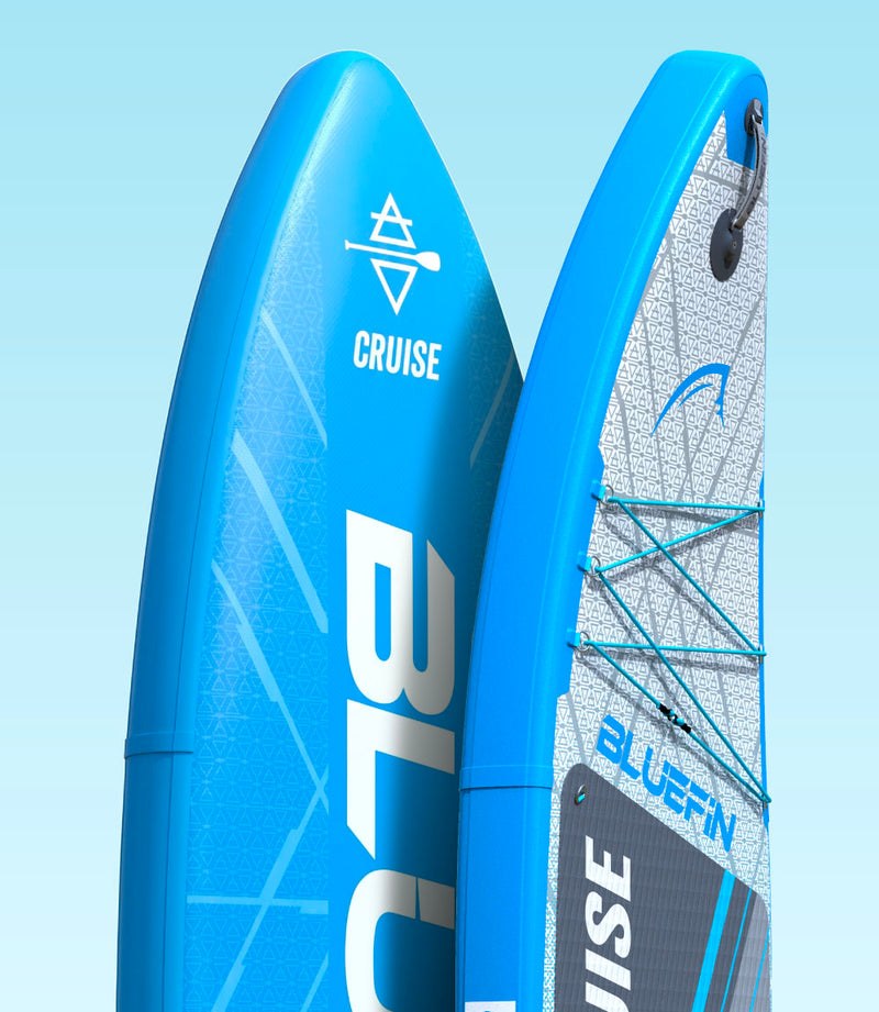 Two inflatable paddleboards in blue, featuring textured deck pads and bungee cord storage.