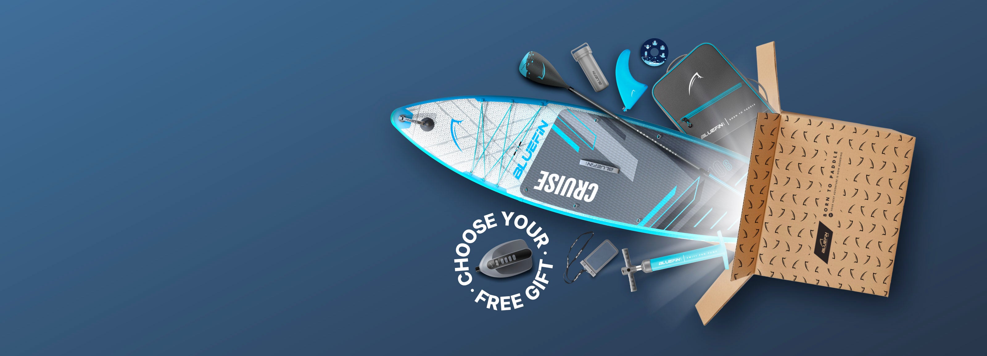 Inflatable paddleboard with accessories, including a paddle, fin, and pump, emerging from a cardboard box.